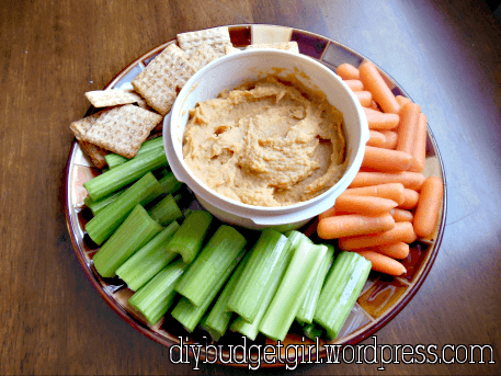 Carrot & White Bean Hummus --- A delicious hummus made with carrots and navy beans. Simple, flavorful, and this recipe makes a ton. There's one secret ingredient that is rather subtle, but really amps up the flavor. || via diybudgetgirl.com #hummus #vegetarian #healthy #light #skinny #secretingredient
