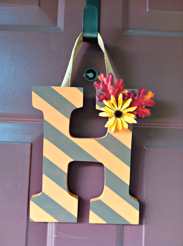 Hand-Painted Letter --- Easy, budget-friendly craft and makes a great substitute for a wreath. || via diybudgetgirl.com #letter #diy #crafts #paint #stripes 