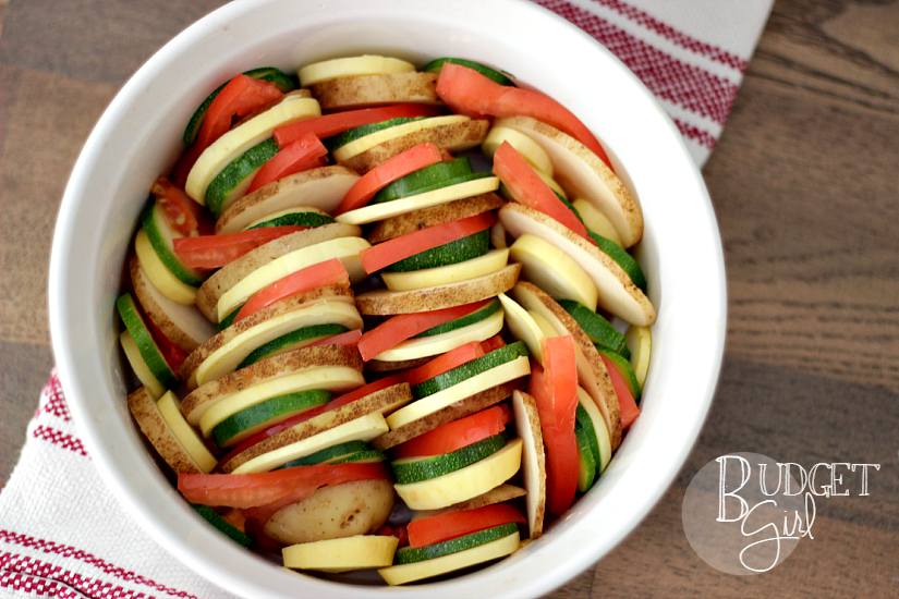 Crispy herbed vegetables covered in pepper jack cheese, perfect as a summer side. This vegetable tian uses zucchini squash, potato, and tomato. You can add onion and eggplant, as well.