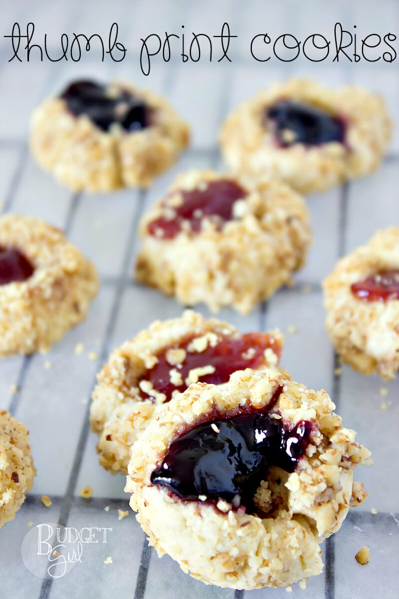 Thumb Print Cookies -- A butter-y, crumbly cookie coated in walnut pieces, with jam or preserves in the center. Thumb print cookies are a family favorite! || via diybudgetgirl.com #cookies #christmas #baking #nuts #thumbprint #familyfavorite 
