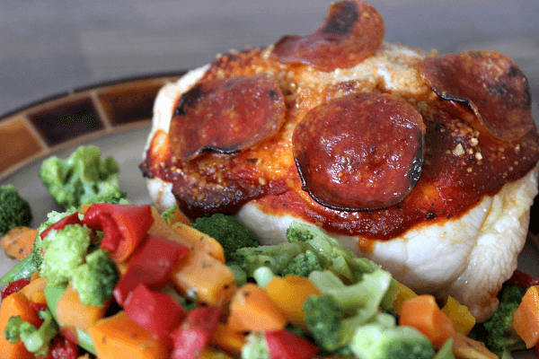 Pizza Stuffed Chicken --- Pizza stuffed chicken gives you the taste of pizza without all the added calories! Only 180 calories per serving, high in protein and, of course, amazing. This healthy dish is a family-favorite. Customize it by adding your favorite pizza toppings! Nutritional Info: 180 Calories, 5 g fat, 5 g carbs, 1 g fiber, 3 g sugar, 30 g protein || via diybudgetgirl.com #chicken #pizza #healthy #stuffed #cooking #recipes