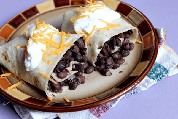 Black Bean Burritos // Budget Girl --- Simple, delicious, and budget-friendly. Dress up the burritos with avocado & tomato OR puree the beans and eat as a soup. Either way, these beans are seasoned perfectly and taste amazing.