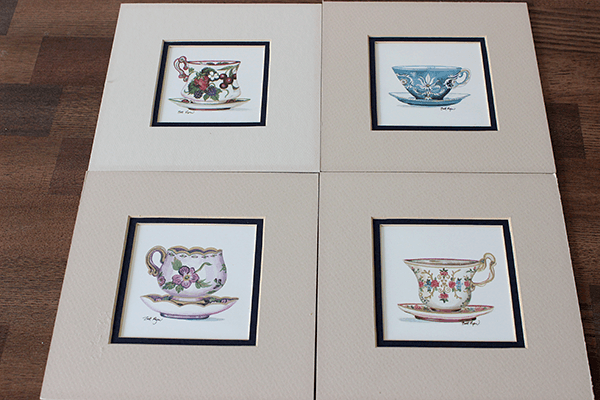 Thrift Store Tea Cup Prints: Before & After --- You'll never believe how new and chic a few coats of paint made these prints look! || via diybudgetgirl.com #prints #teacup #thrift #paint #diy #decor #dining #kitchen
