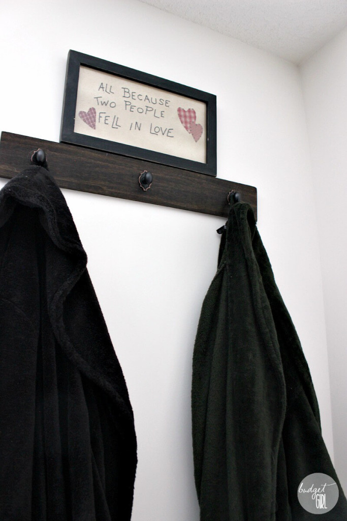 Easy DIY Robe Hanger --- This cost less than $15 to make and the hardest part was hanging it. Such a simple and pretty way to get your robes off the floor. || via diybudgetgirl.com #diy #crafts #bedroom #decor #design #clothes #organization