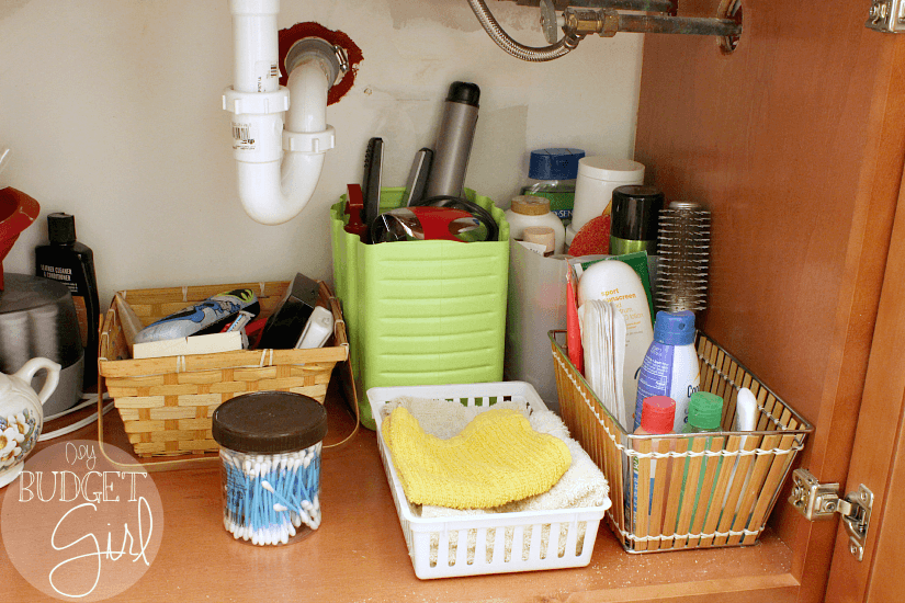 Organize with Cat Litter Containers --- Part of living on a budget means figuring out how to reuse things you already buy. I use my old cat litter containers to organize the space under my bathroom vanity. Here's how! || diybudgetgirl.com #organization #cheap #budget #recycle #reuse #bathroom 