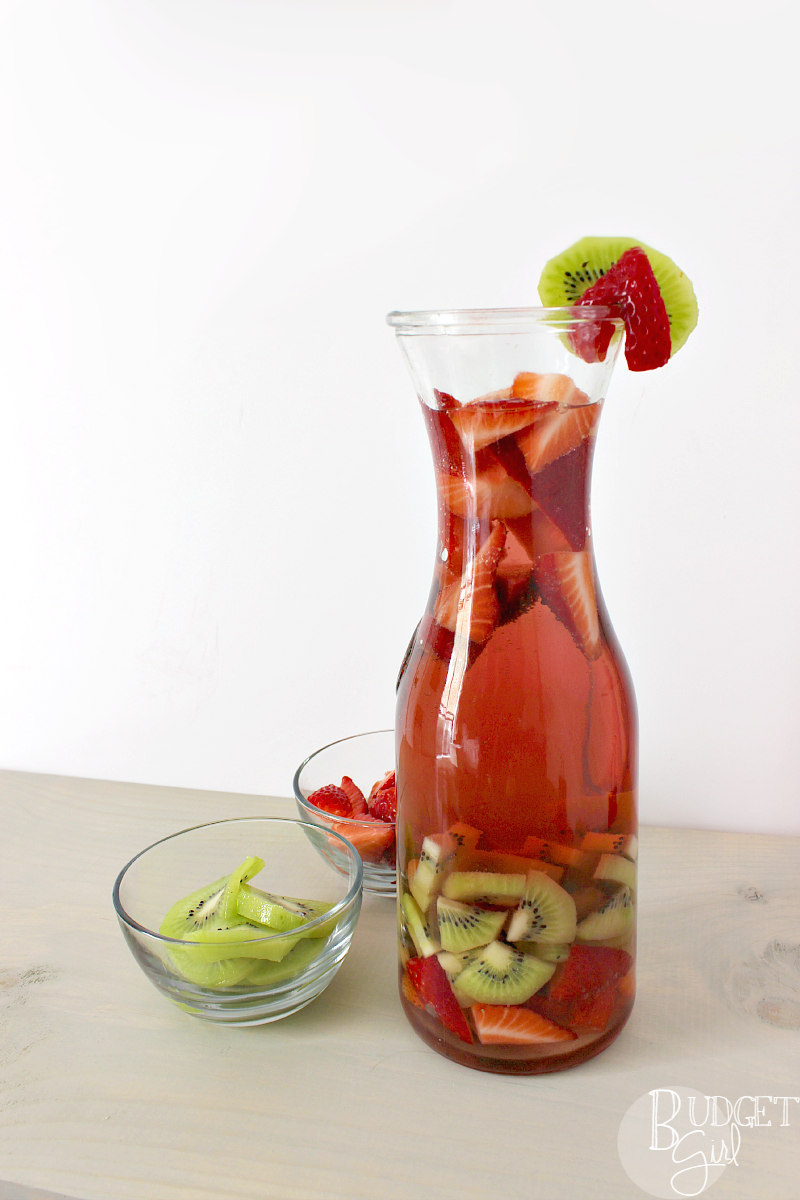Strawberry Kiwi Sangria is simple to make, pretty to look at, and perfect for both brunch mimosas and summer evenings relaxing on the porch. || via diybudgetgirl.com #sanrgia #wine #strawberry #kiwi #spring #summer #fruit #moscato