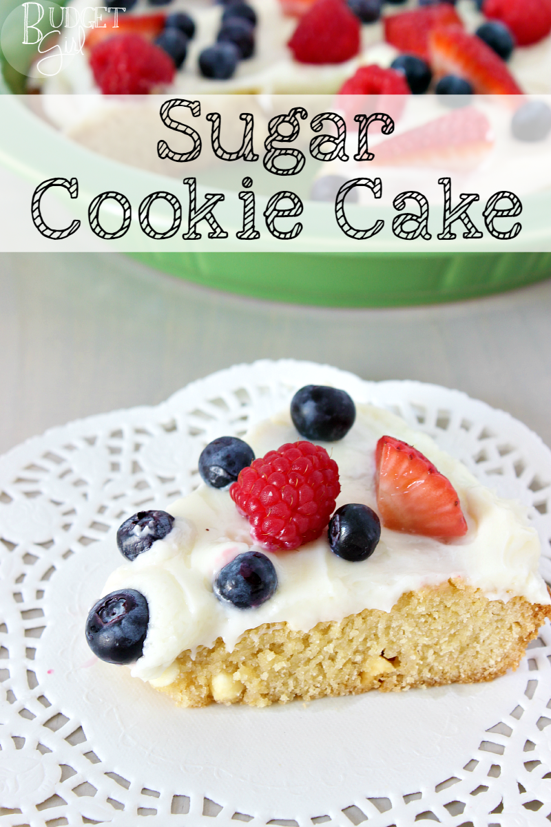Sugar Cookie Cake --- A tender sugar cookie cake, filled with white chocolate chips, topped with cream cheese and fruit. A perfect dessert for the Fourth of July and other summer holiday parties. || via diybudgetgirl.com #sugar #cookie #cake #baking #summer #recipes #easy #fruit #creamcheese #topping #frosting #icing #cream #cheese 