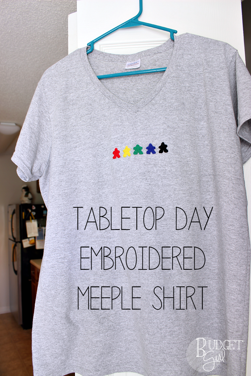 TableTop Day Embroidered Meeple Shirt --- Celebrate TableTop Day with this colorful, customizable embroidered meeple shirt!. Use the base game colors or colors of your choice. || via diybudgetgirl.com #tabletop #tabletopday #tshirt #shirt #meeples #embroider #embroidery #boardgames #games #gaming #crafts #diy