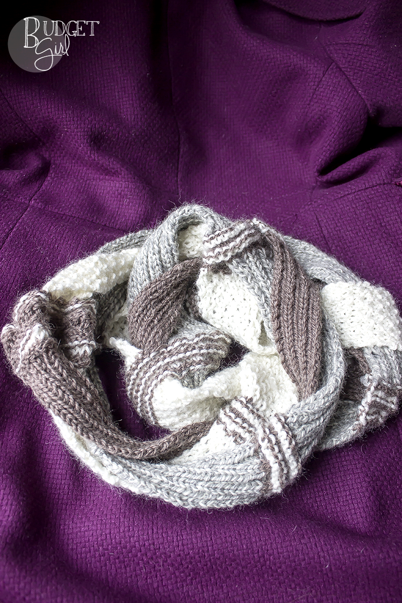 The challah infinity scarf is a textured, chunky-looking scarf using moss stitch and rib stitch. It's worked in three strips that are braided and stitched together to create its unique look.